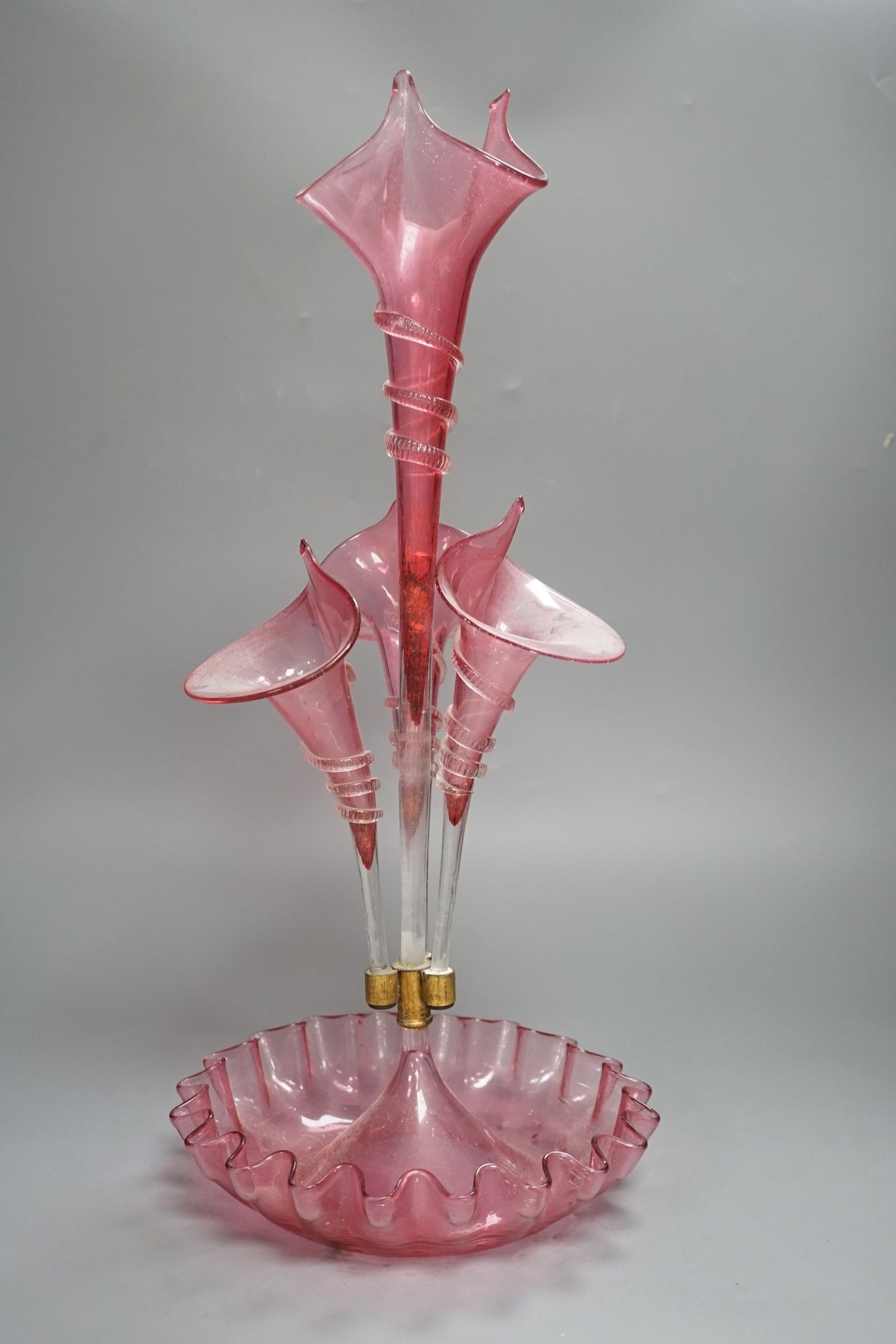 A Victorian cranberry glass four vase table centrepiece, 52 cms high.